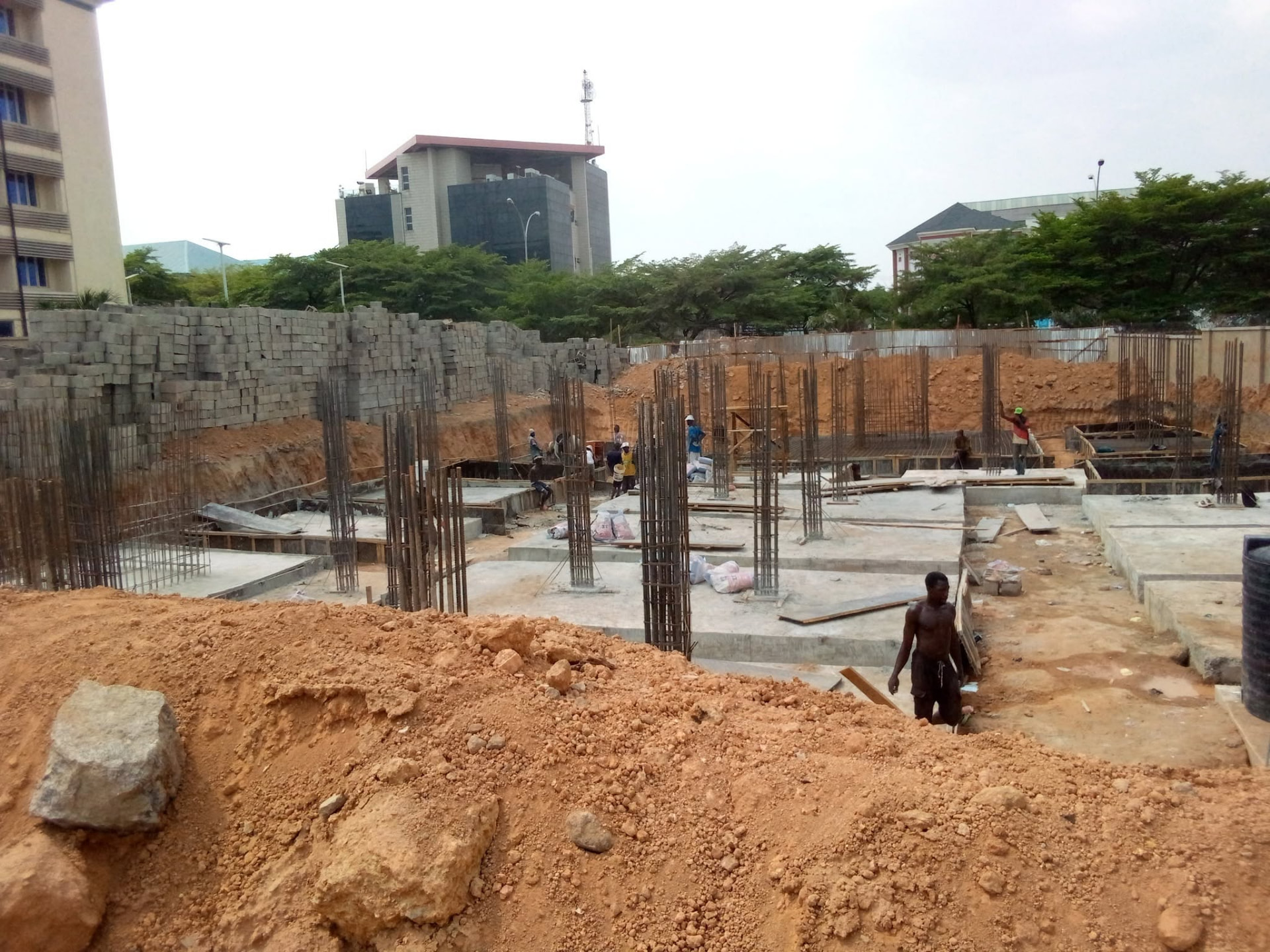 Reinforced concrete foundations and workers on site