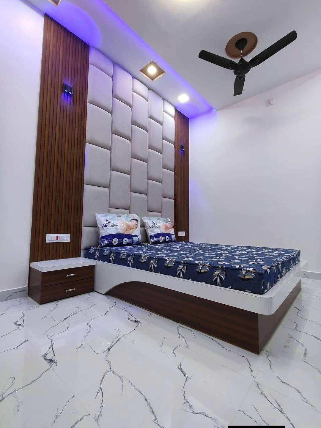 Bedroom with upholstered panel headboard wall and LED cove