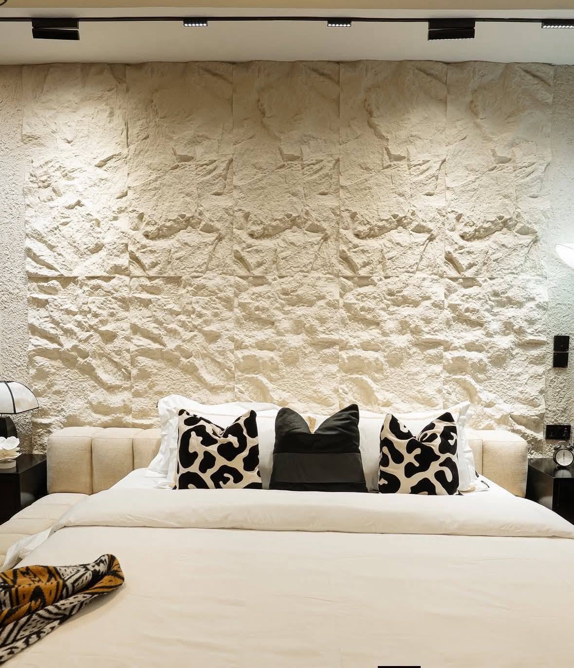Bedroom stone feature wall with track lighting detail